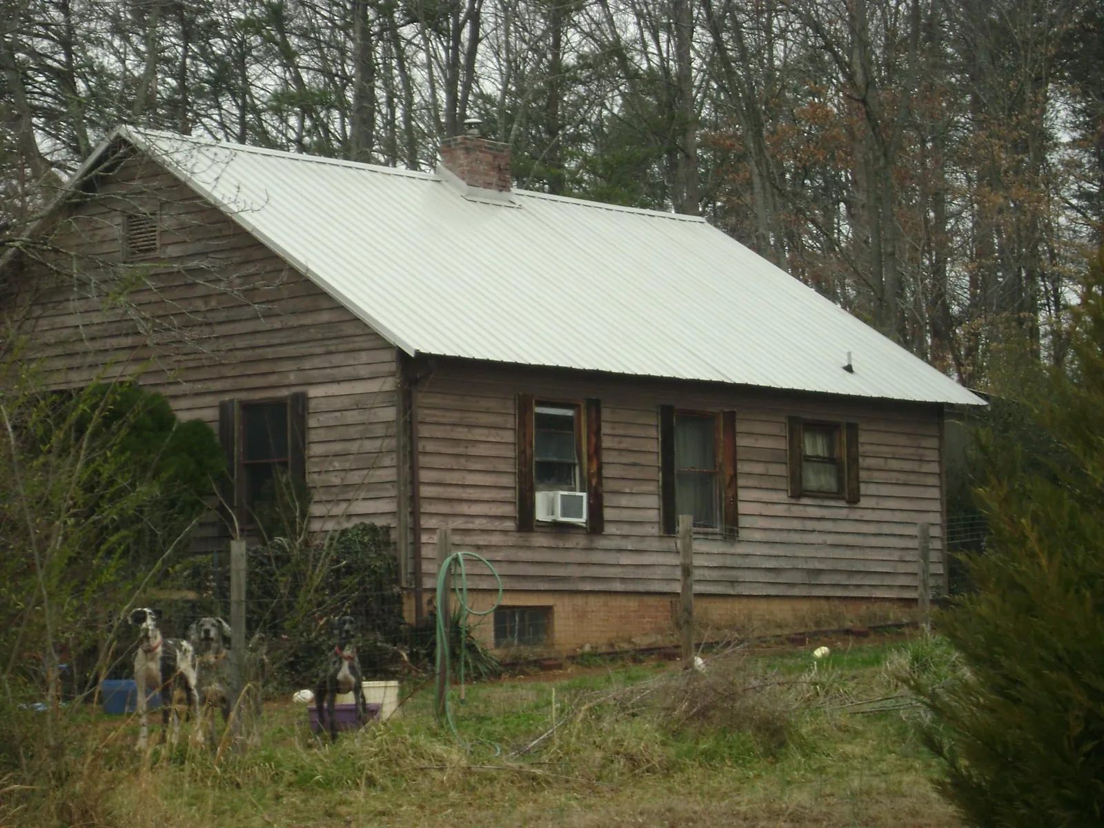 White metal roof on an old wood sided farmhouse, from a Metal Roof Installation job in Stanton